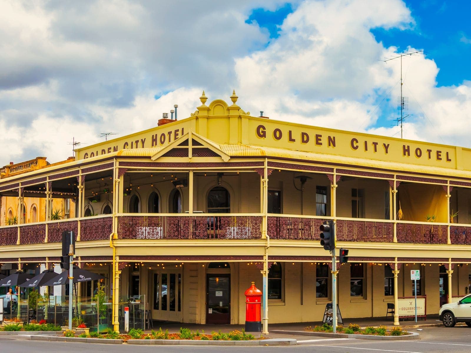 A two-storey Victorian corner hotel with wrought-iron verandah balustrades